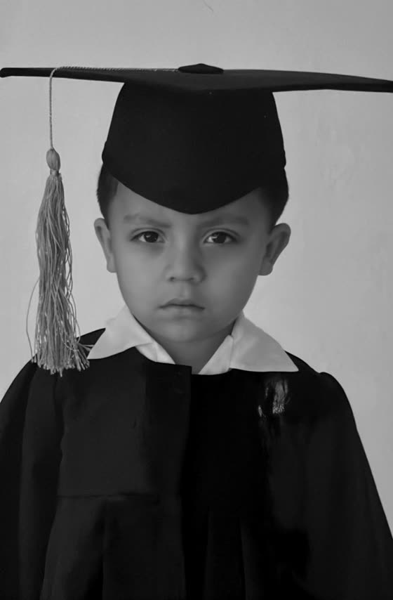 Kindergarten graduation portrait in cap and gown